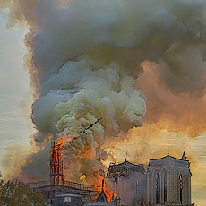 The spire in the middle the roof of Notre-Dame Cathedral burning and falling on Monday April 15th 2019.