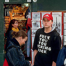 A teenager wearing a t-shirt reading “Fuck you, you fucking fuck” in Montmartre.
