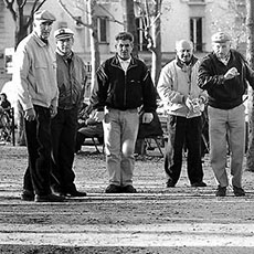 Seven men men playing pétanque in place de la Nation.