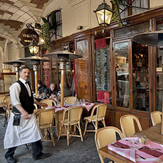 A waiter walking into the Ma Bourgogne restaurant in place des Vosges.