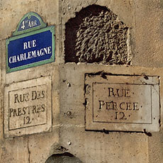Five street signs at the corner of rue Charlemagne and rue du Prévôt.