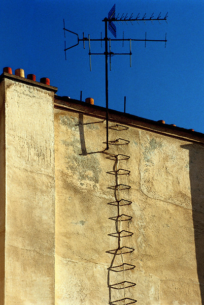 Shadows of a ladder on a chimney on rue Vieille-du-Temple.
