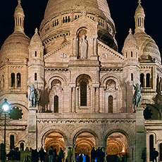 The main façade of Sacré-Cœur at night.