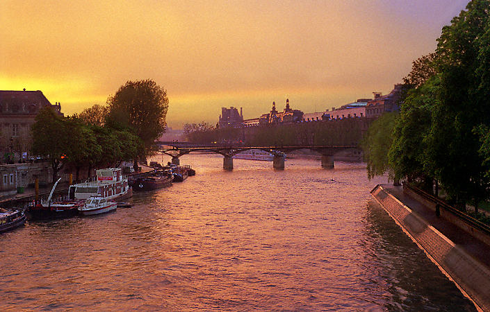 Le pont des Arts, le musée du Louvre et l’île de la Cité au coucher de soleil.