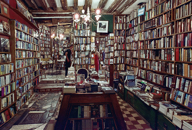The interior of Shakespeare and Company at night.