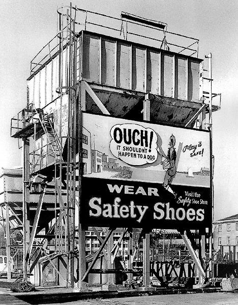 A sign advising workers to wear safety shooes in Charlestown.