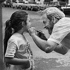 A dentist examining a girl’s teeth outside in Boston.