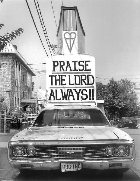 A car with signs displaying religious slogans in Somerville.