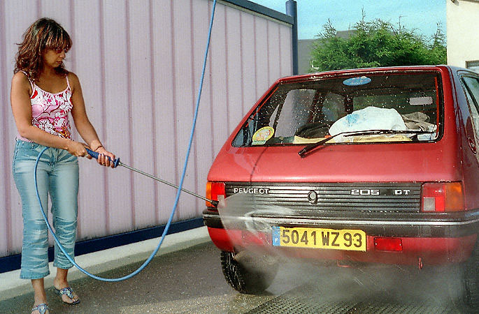 A woman washing a car in Cabourg, France.