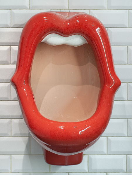 A urinal in the shape of a woman’s mouth in the men’s at the Belushi’s bar in Paris.