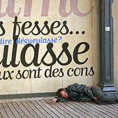 A homeless man sleeping in front of the MK2 cinéma in Paris.