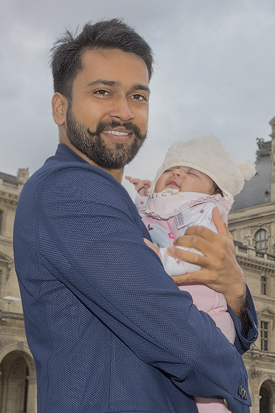 Pulkit Goel and baby daughter in the Louvre Museum’s cours Napoléon.