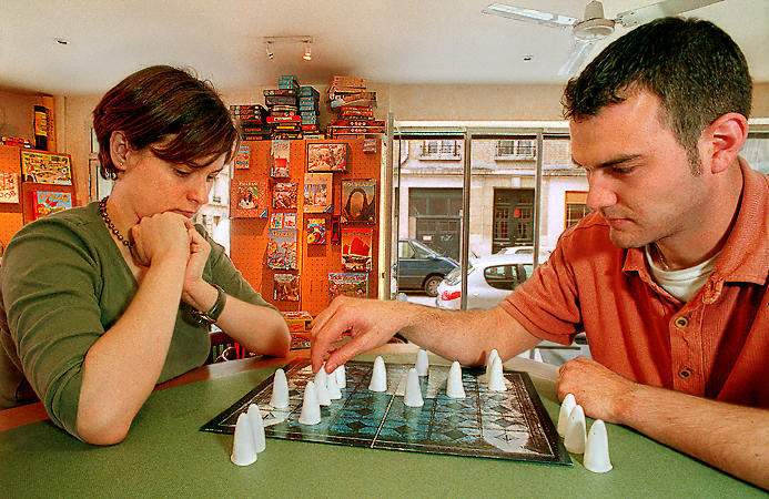 Two people playing a game inside the OYA shop.