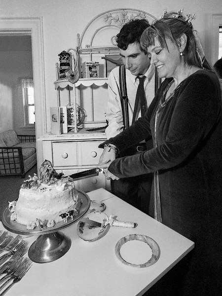 Edward Engel and Sue Hartke move in to wedding cake cutting mode.