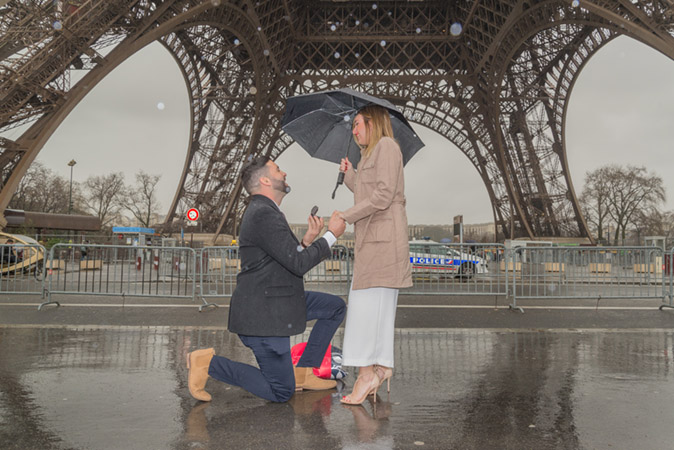 Manny Sagot proposing marriage next to the Eiffel Tower.